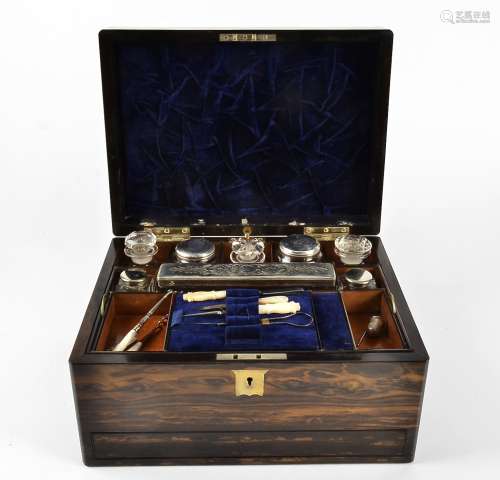 A Victorian coromandel dressing box, the hinged lid and escutcheon inset with brass, opening to