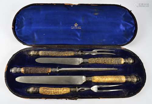 A Mappin & Webb carving set, with antler handles and silver mounts, Sheffield 1912, comprising of