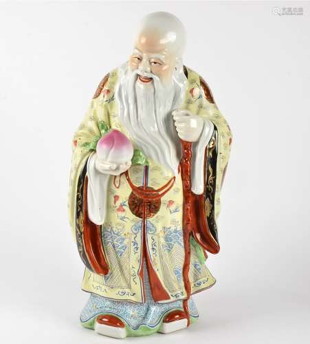 A large 20th Century Chinese figure of an immortal, clasping the peach of longevity, height 52cm