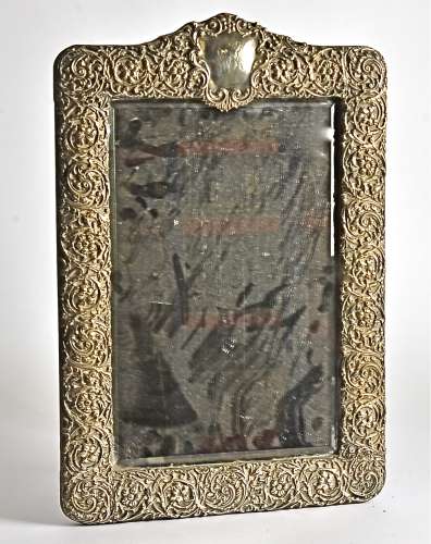 An ornate silver table mirror, hallmarked Birmingham, possibly Henry Matthews c1913, of