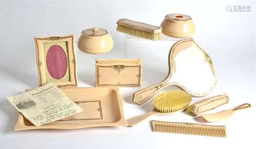 An Art Deco eleven piece tuscaloid dressing table set, comprising of a tray, 28.5cm x 20cm,