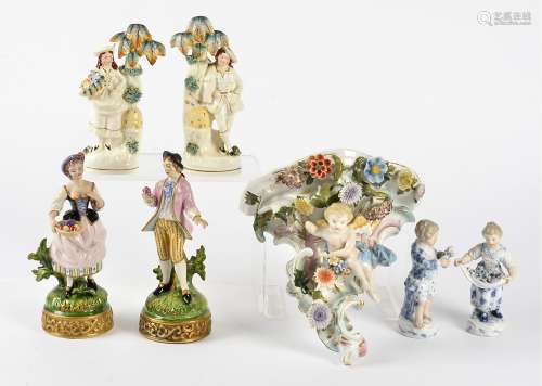 Six continental porcelain figures and a wall bracket, including a pair of male and female figures