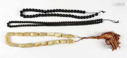 A string of Middle Eastern mother of pearl worry beads, with a red and gold silk strung tassel