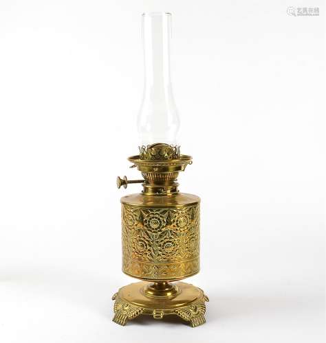 A Victorian brass oil lamp, with floral design, height 30cm, with glass chimney,