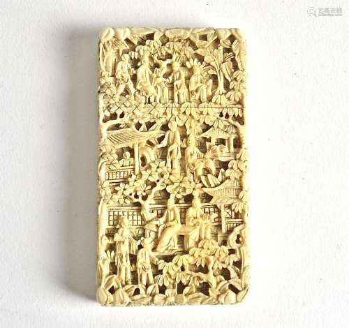 A Chinese ivory card case, profusely carved to reveal figures, pagodas and a dog, dimensions 8.5cm x