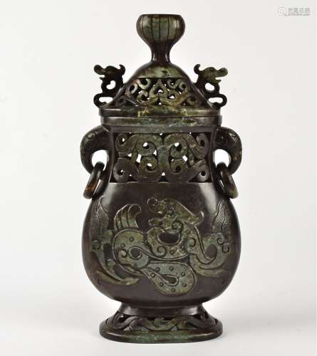 A soapstone twin-handled covered vase, of archaistic form, with elephant ring handles and central