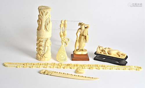 An erotic ivory carving of a reclining nude, on an ebonised stand, length 10cm, together with
