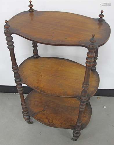 A Victorian walnut three tiered whatnot, three shaped shelves with turned supports, finished with