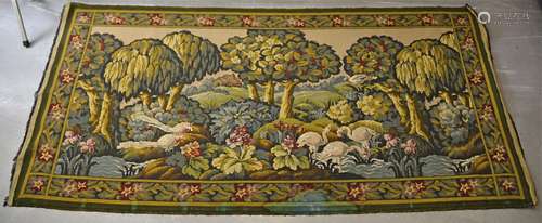 A 20th Century machine made wall tapestry, depicting birds within a woodland within a floral border,