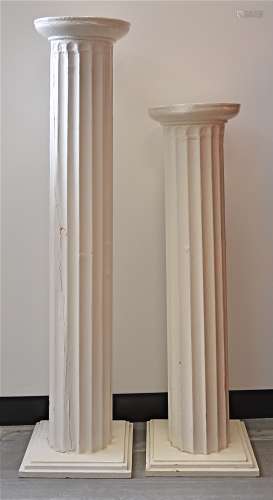 Two 20th Century hardwood plinths, modelled as Roman columns with square bases, painted white,
