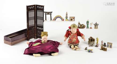 A pair of toy hand puppets in Asian dress, one with an attached Chinese token, largest approximately