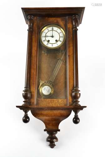 A late 19th Century Vienna style walnut wall clock, white enamel dial with Roman numerals, above a