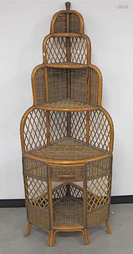 A contemporary rattan corner unit, with graduated shelves and frieze drawer 71cm x 50cm x 188cm