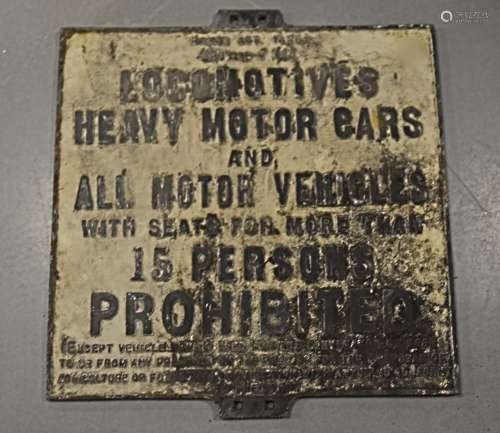 A vintage cast iron road sign, rectangular and stating 'Locomotives, Heavy Motor Cars and all