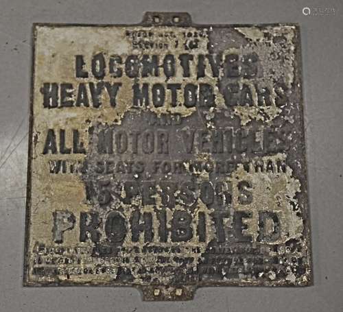 A vintage cast iron road sign, rectangular and stating 'Locomotives, Heavy Motor Cars and all