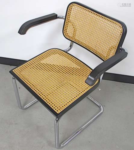 After Marcel Breuer a cantilever caned armchair, tubular caned seat and back with ebonised supports