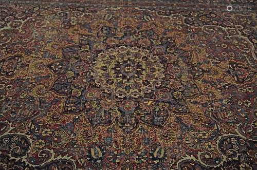 A large 20th Century woollen rug, with central medallion upon a blue foliate ground, with blue, pink