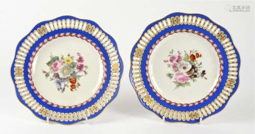 A pair of continental pierced porcelain plates, with central floral decoration, and crossed swords