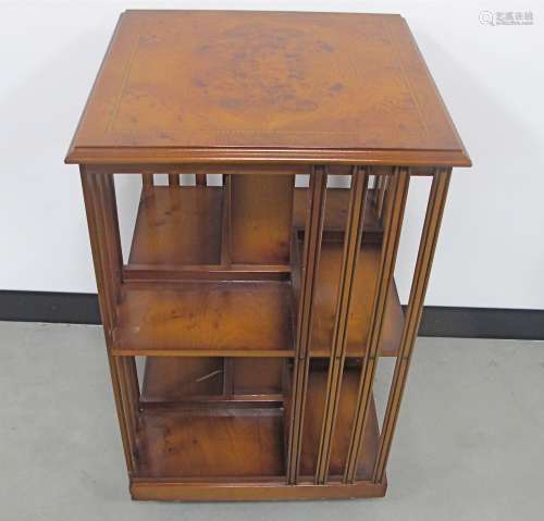 A contemporary yew wood revolving bookcase, approximate height 80cm