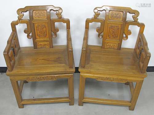 A pair of Chinese hardwood carved temple chairs, the wooden seats with carved back splat design,