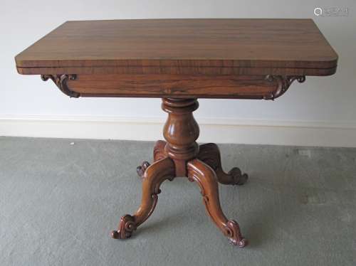 A William IV rosewood card table, with swivel fold over top, revealing a green circular baize,
