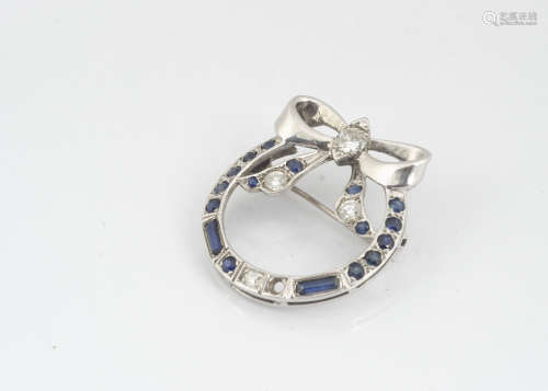 A continental 14ct white gold sapphire and diamond bow brooch, the centre of the bow with old cut