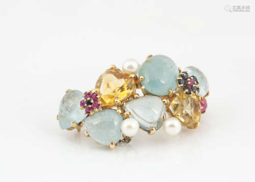A continental 14k marked multi gem set brooch, the claw set gems comprising sapphires, rubies,