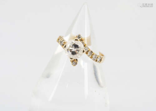 A continental yellow metal and diamond solitaire, the brilliant cut in four claw setting on a