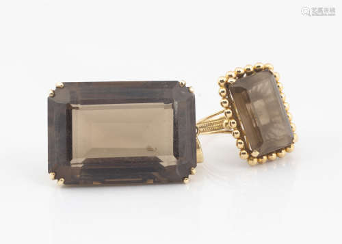 A continental smoky quartz dress ring, the yellow metal basket and rope twist setting with centred