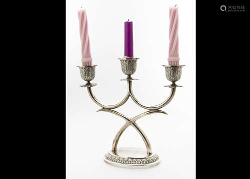 A c1960s Thai silver filled candle holder, oval base with X shaped support for three sconces, marked