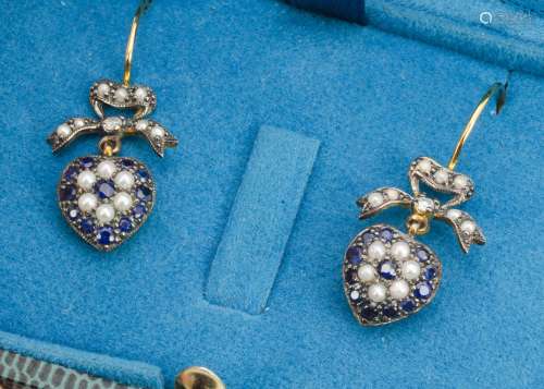 A pair of sapphire, diamond and seed pearl earrings, of heart drops, with bow tops on gold loops,