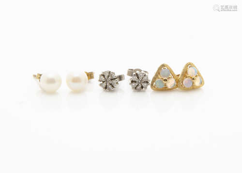 A pair of diamond cluster studs, a pair of white precious opal studs and a pair of cultured pearl