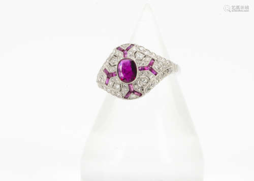 A ruby and diamond Art Deco style dress ring, the oval mixed cut within a pierced setting, set