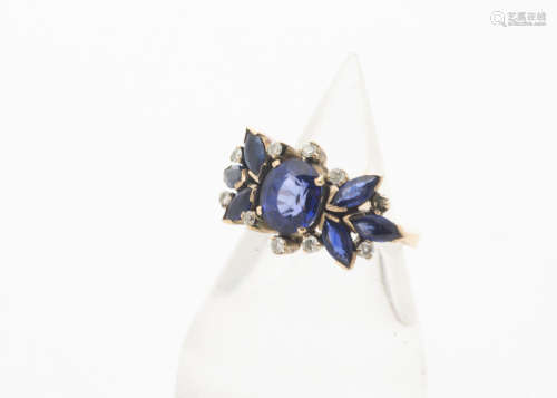 A sapphire and diamond dress ring, the oval mixed cut sapphire in four claw setting, surrounded by