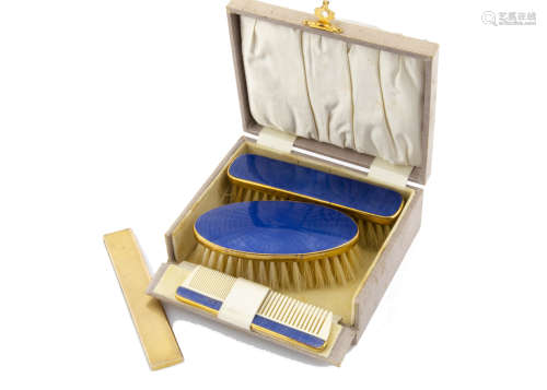 A 9ct gold and tortoiseshell slide comb, the engine turned casing with cabochon blue paste button