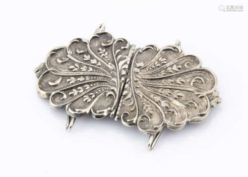 A silver plated Art Nouveau nurses belt buckle, the shaped outline with scroll and leaf design