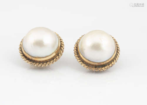 A pair of continental yellow metal and mabe pearl ear studs, of circular clip form in rope twist
