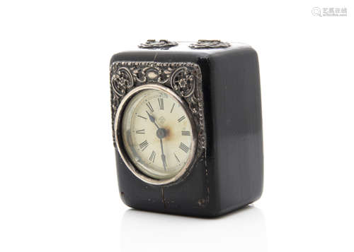 An American travel clock, the ebonised case with silver mounts, damaged to lower front, crack to