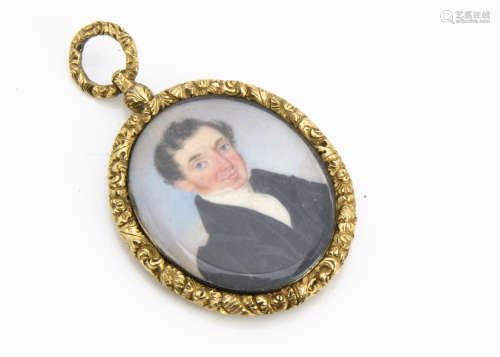 An early 19th Century portrait miniature hanging fob, the oval three quarter length portait of a