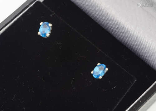 A pair of blue apatite and silver claw set studs, boxed