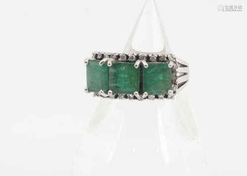 A continental emerald and diamond three stone dress ring, the square cut emeralds in four claw