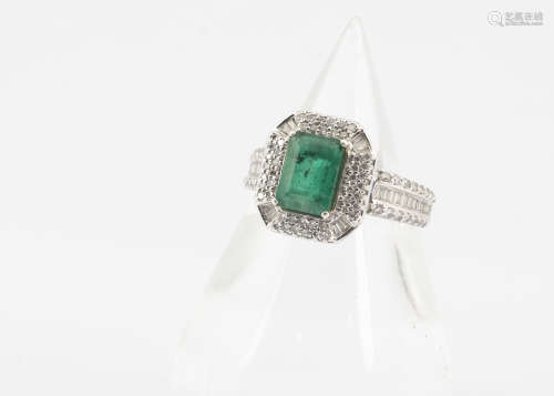 An emerald and diamond dress ring, in the Art Deco style, the emerald cut in four claw setting