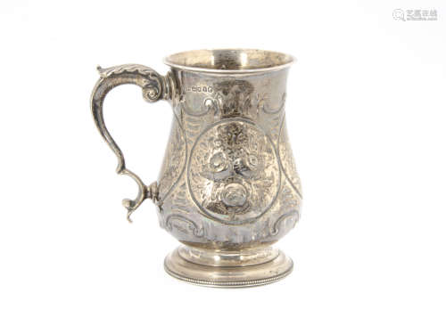 A Victorian silver tankard by AGP, London 1861, bulbous body with embossed decoration, 10.7 ozt,