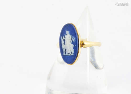 A 19th Century 18ct gold and Wedgwoodblue jasper dress ring, the navette shaped blue panel decorated