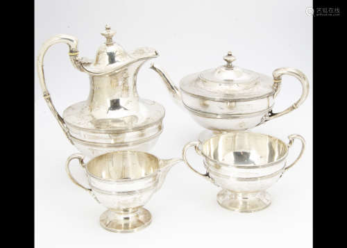 A George V silver four piece Scottish silver tea set by JF, Glasgow 1927, comprising teapot, hot