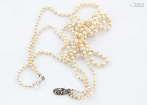 A three strand graduated cultured pearl knotted strung necklace, the pearl strings united by a