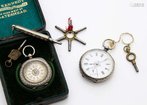 Two late 19th century silver ladies pocket watches, one with wide textured bezel in a box, also a