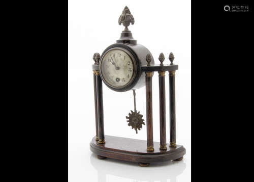 A late 19th century mantle clock, drum 30 hour movement in wooden surround having vase and flower
