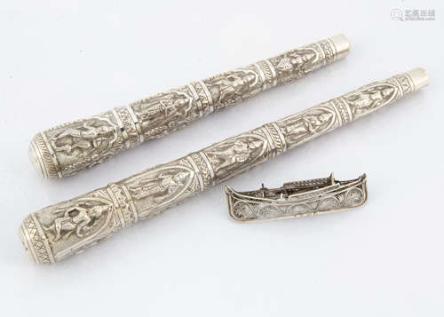 Two vintage Indian silver parasol handles, each with raised designs of figures, 25cm and 20.5cm, 5