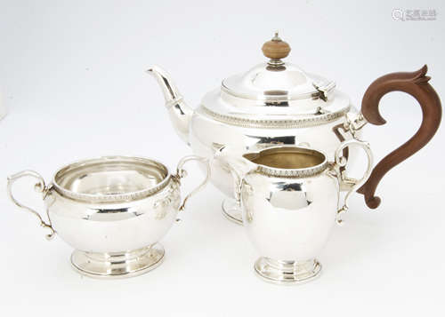 An Art Deco three piece silver tea set by ISG, Birmingham 1929, 35 ozt, with socle bases and stylish